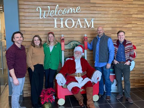 Santa with executives at a corporate holiday party
